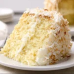 Delicious coconut cake with cream cheese frosting on a plate