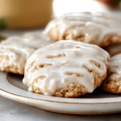 Delicious no-bake cinnamon roll cookies on a plate with icing