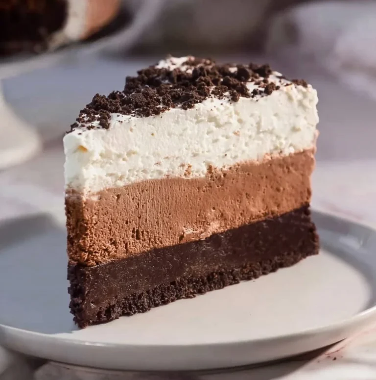 Delicious Oreo Mousse Cake topped with crushed Oreos and whipped cream