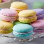 Colorful pastel sugar cookie sandwiches filled with creamy frosting