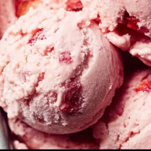 Delicious homemade strawberry ice cream in a bowl with fresh strawberries