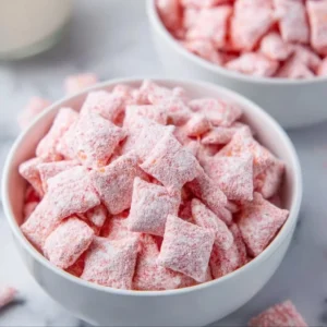 Quick Strawberry Shortcake Puppy Chow dessert recipe with strawberry flavor.