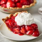 Freshly baked strawberry pie topped with whipped cream